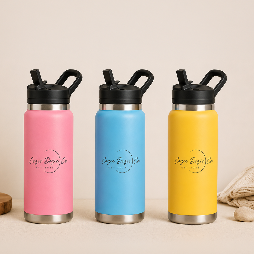 Three Cozie Dozie Co. 27oz vacuum-insulated stainless-steel kids drink bottles in Pink, Blue, and Yellow with flip sippy straw lids.
