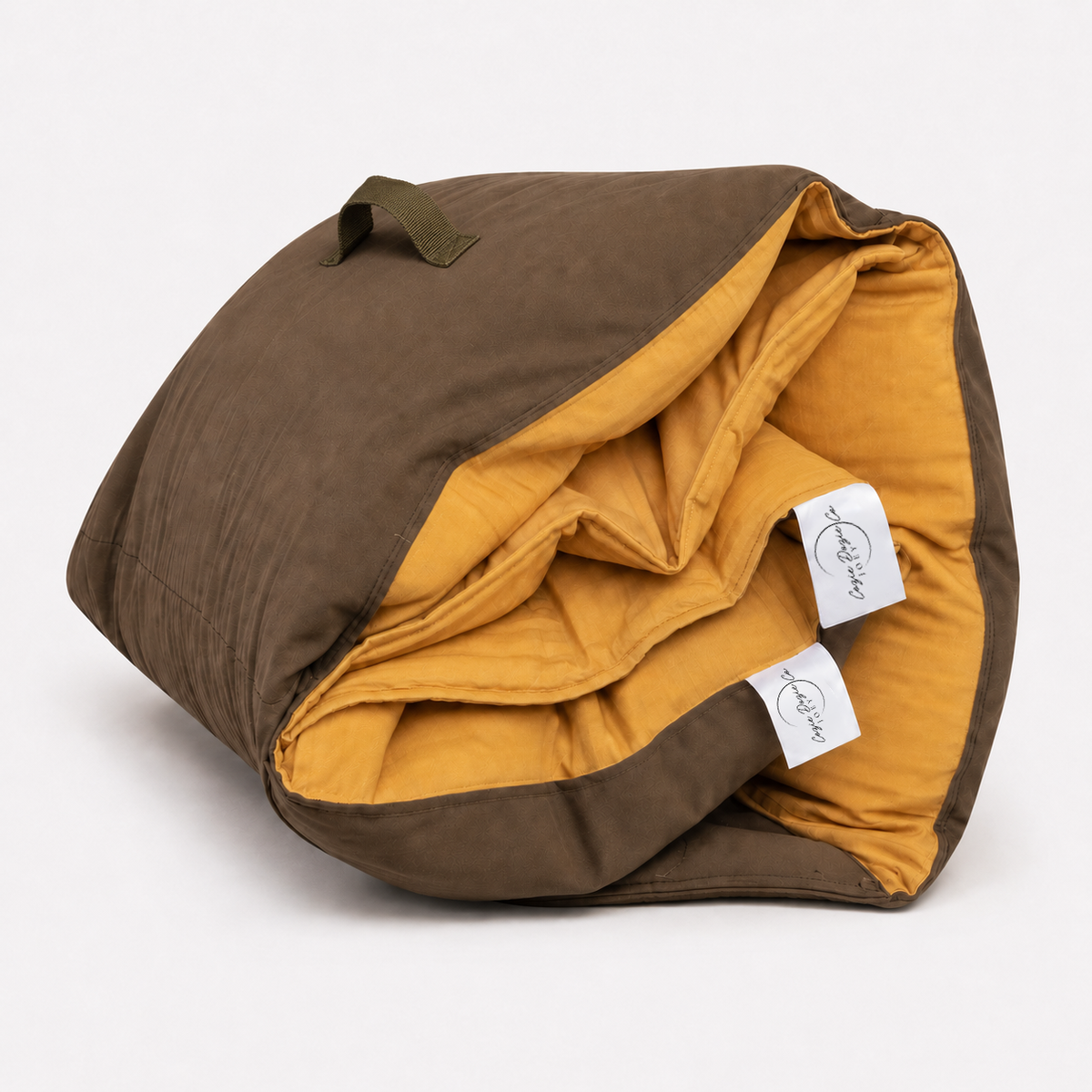 Rolled Cozie Dozie Co. Joey adventure lounger cover in warm Ochre French linen with brown canvas backing.