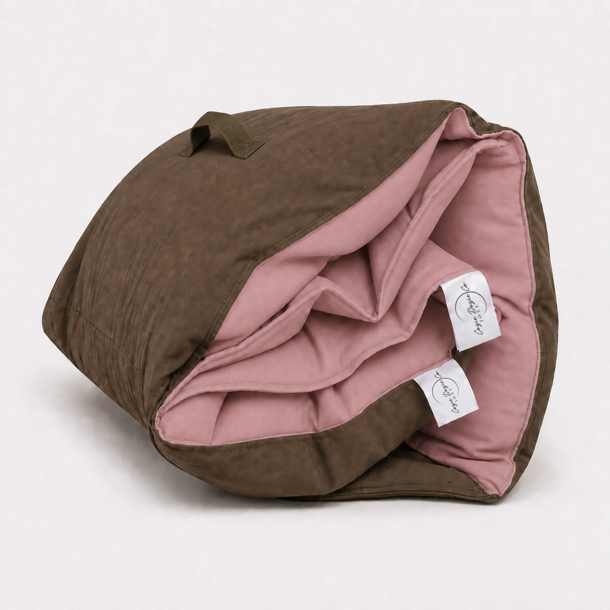 Rolled Cozie Dozie Co. Joey adventure lounger cover in soft Quartz pink French linen with brown canvas backing.