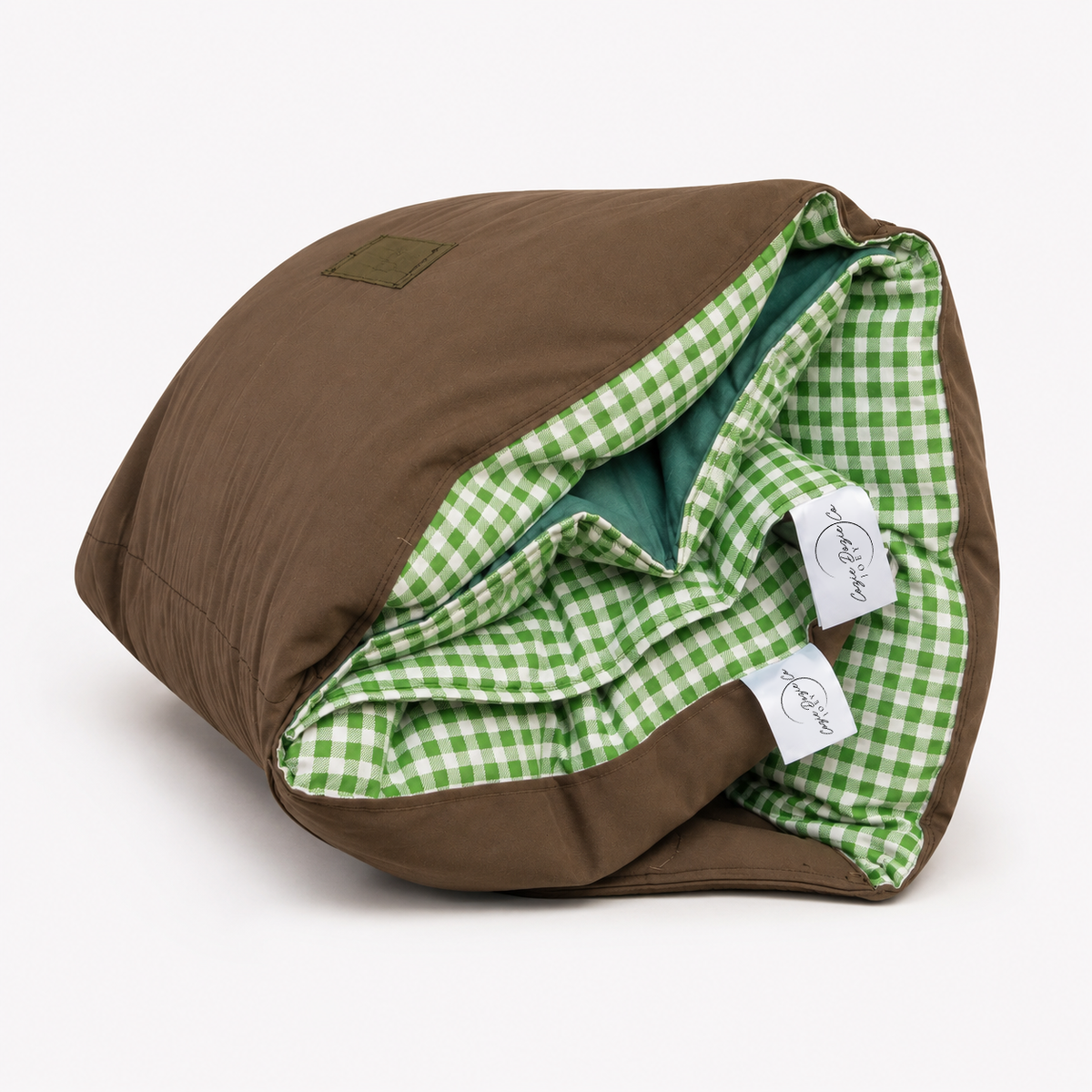 Rolled Cozie Dozie Co. Limited Edition Warrigal Greens Joey adventure lounger cover showing green gingham lining and canvas backing against a white background.
