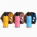 Three Cozie Dozie Co. stainless steel drink bottles in Ochre yellow, Quartz pink, and BowerBird Blue positioned in front of their matching rolled Joey adventure loungers on a white background.